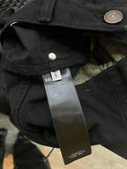 Black denim jeans waistband with button closure and Balenciaga Jeans fabric label.