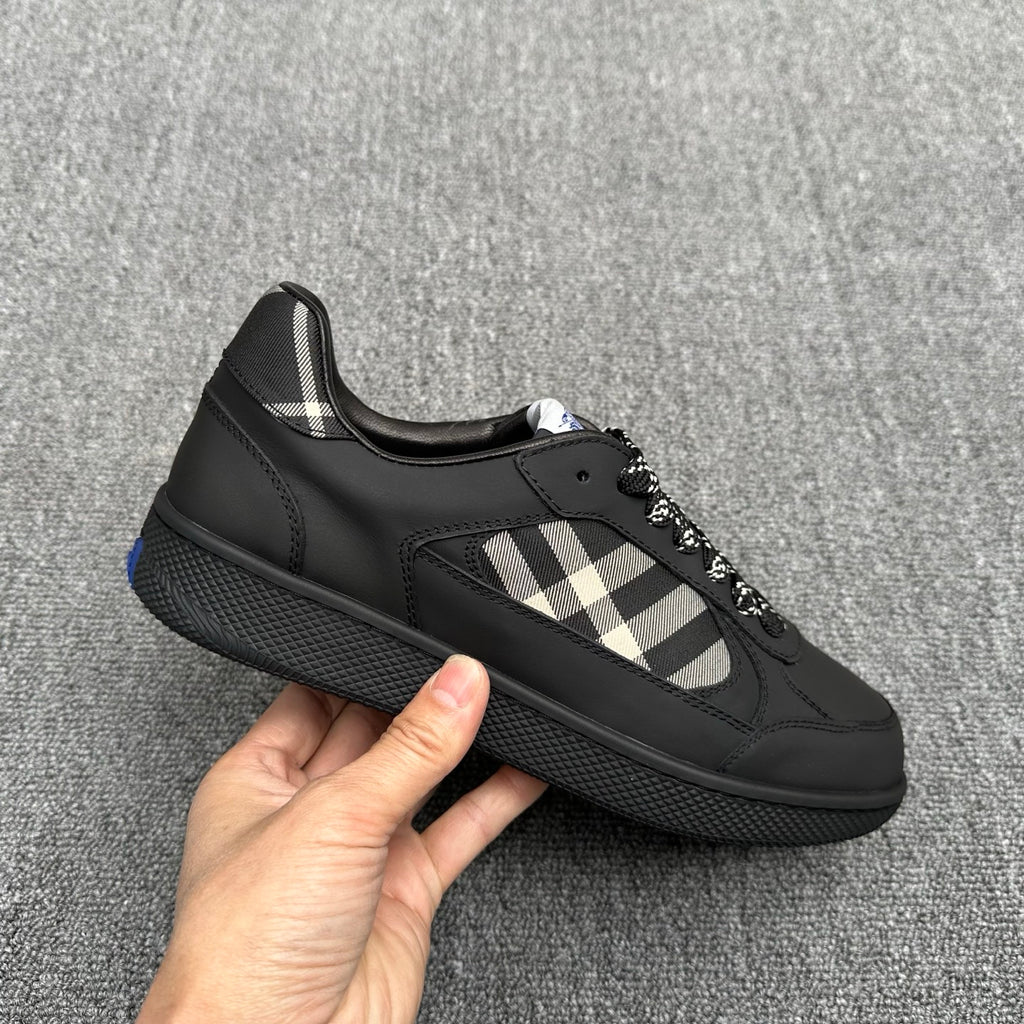 Black low-top sneakers with check-pattern stripe and textured sole