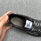 Black sneaker interior view with BURBERRY branding and check-pattern laces