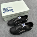 Black sneakers with check-pattern side panels and braided laces