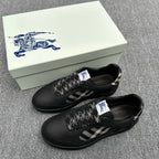 Black sneakers with check-pattern side panels and braided laces