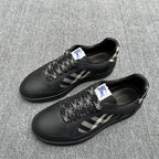 Black sneakers pair with check-pattern side panels and lace-up closure