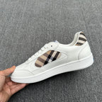 White lace-up sneakers with plaid side panels and blue horse logo at tongue