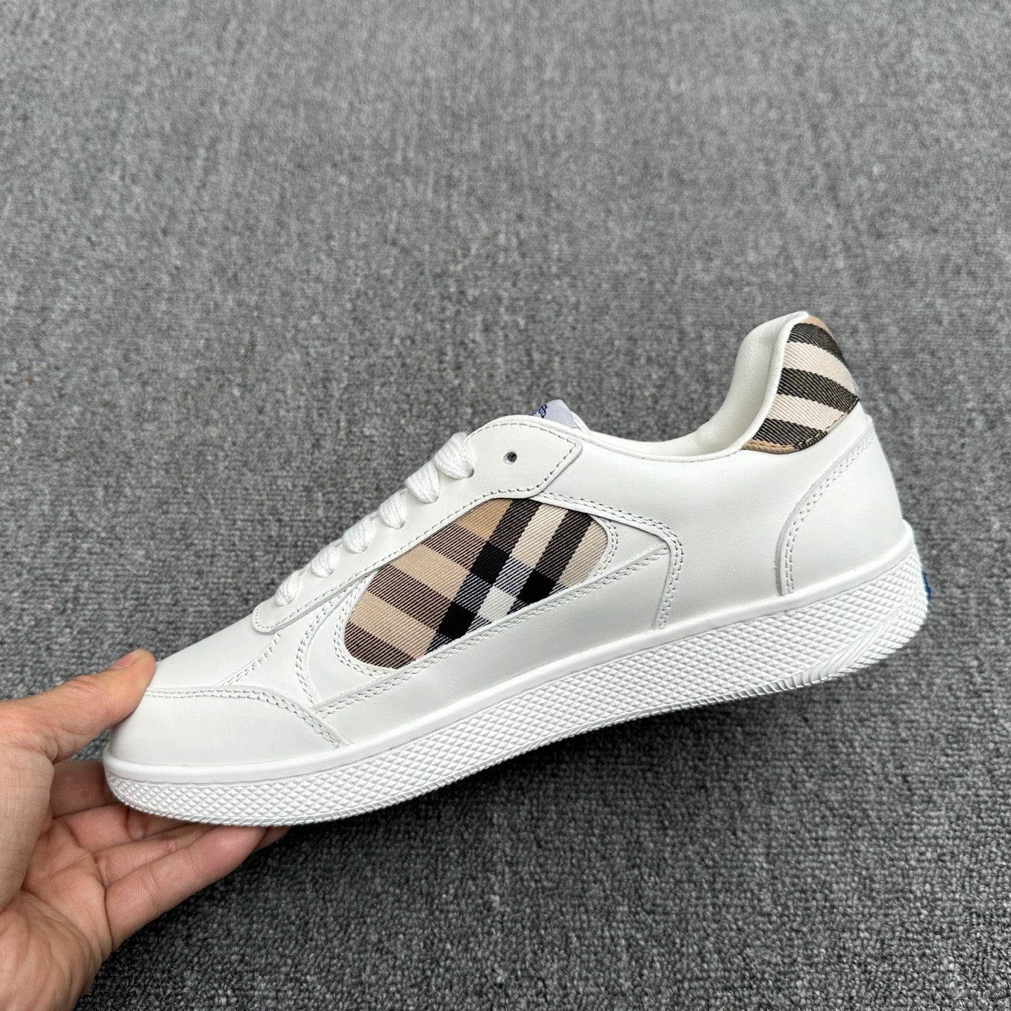 White lace-up sneakers with plaid side panels and blue horse logo at tongue