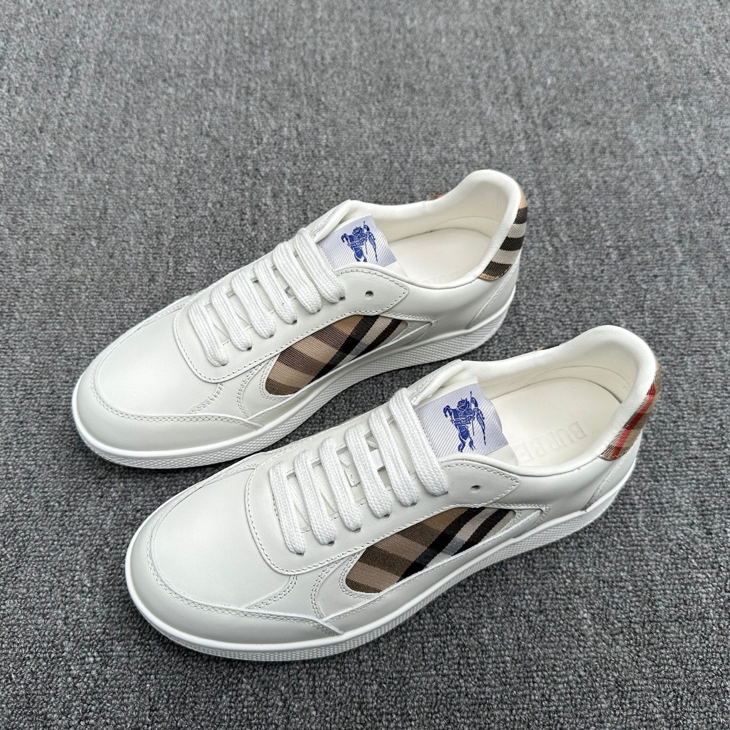 White sneakers with plaid side panels, lace-up front, and blue horse logo