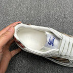 White sneaker interior view with Burberry text and blue horse logo on insole