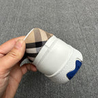 White sneaker heel with plaid lining detail and blue logo accent