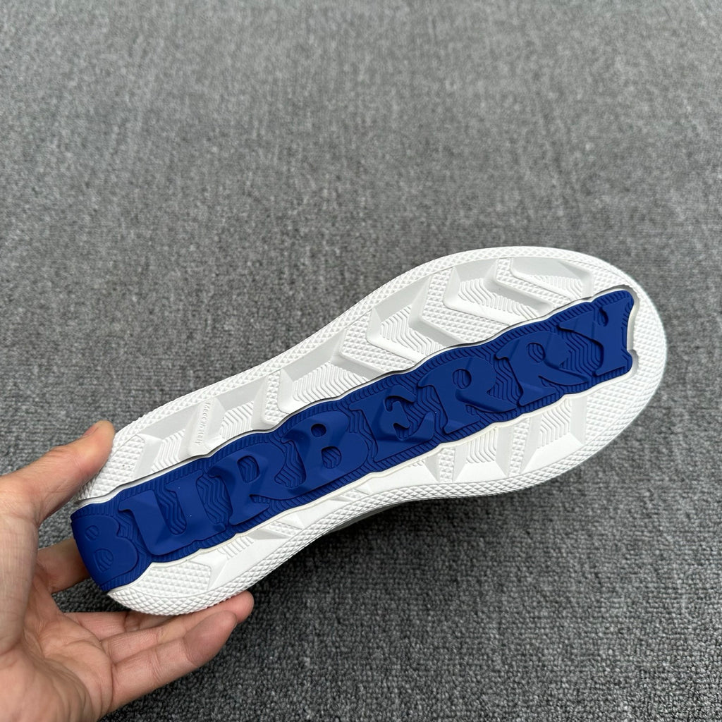 White sneaker outsole with blue textured logo tread