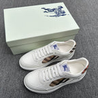 White leather sneakers with plaid side panels and blue logo on tongue