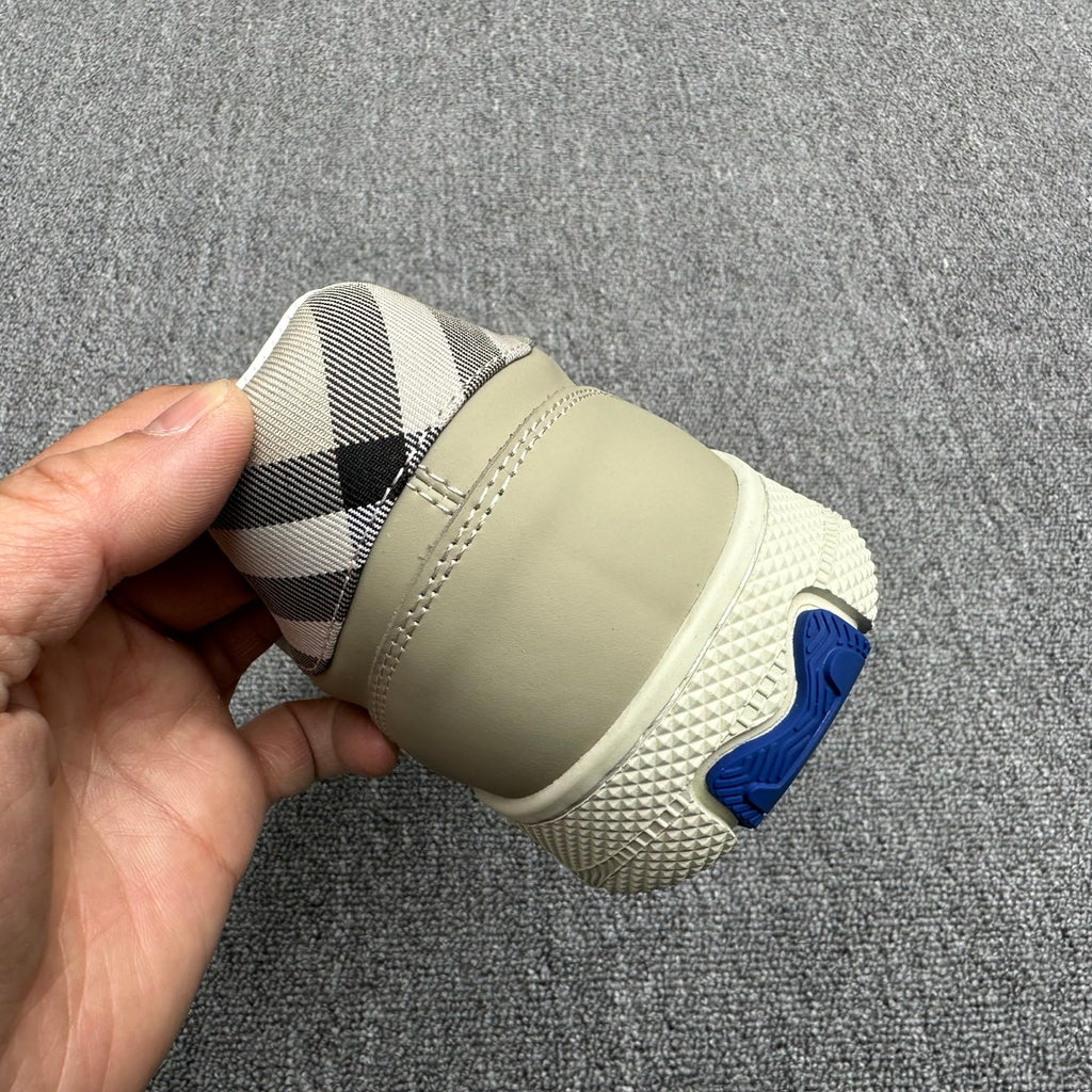 Burberry sneaker heel, beige sole with blue rubber logo and check interior lining