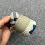 Burberry sneaker heel, beige sole with blue rubber logo and check interior lining