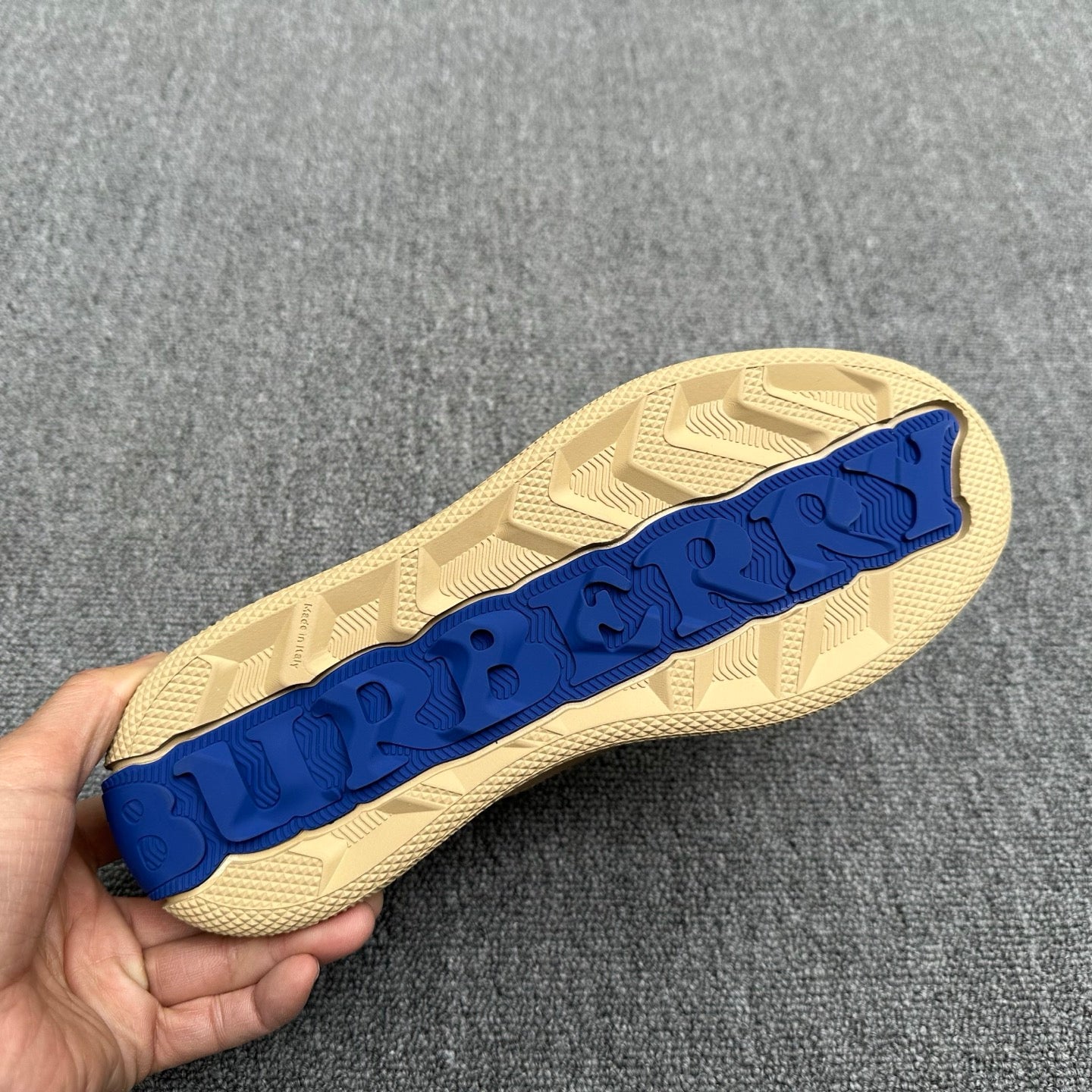 Burberry sneaker outsole with textured tread and blue rubber strip
