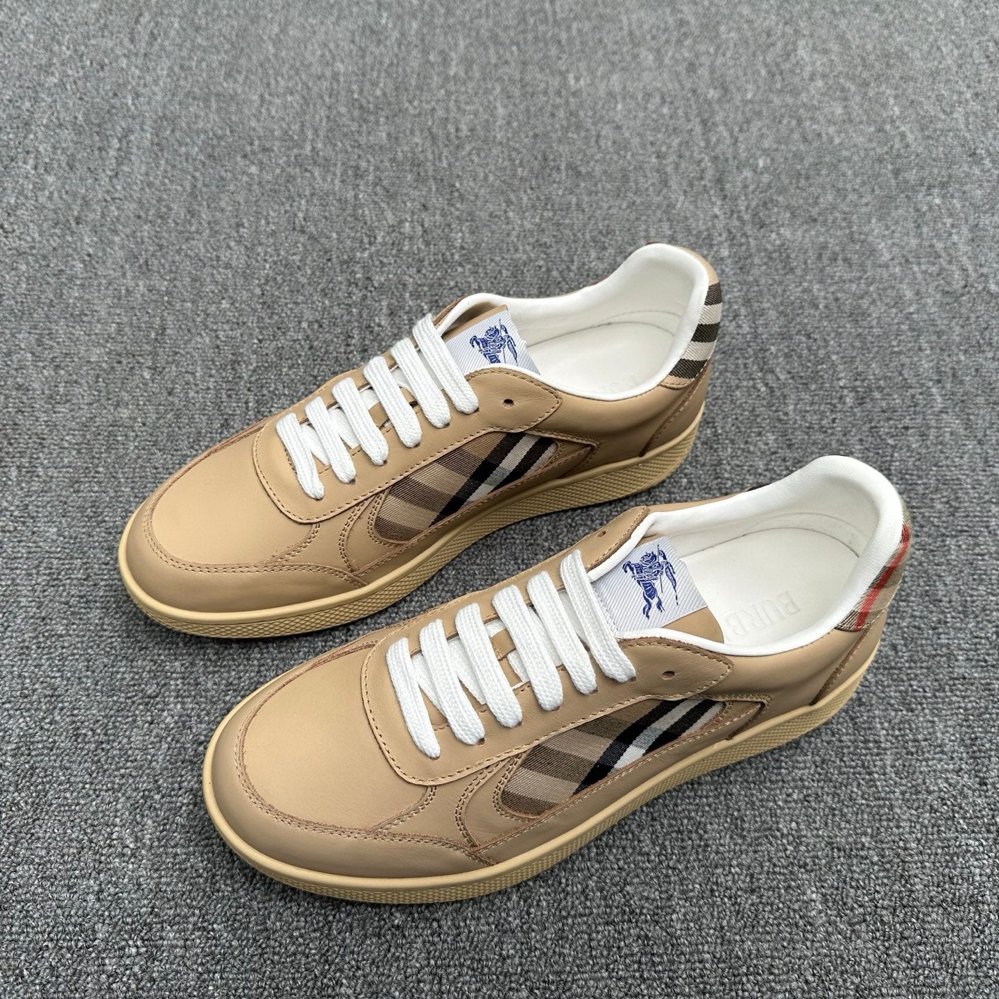 Burberry beige sneakers with check stripe and white laces, side view of pair