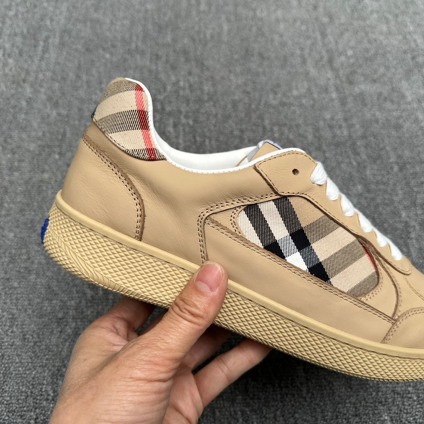Burberry beige sneaker close-up, check panel, white laces, textured sole