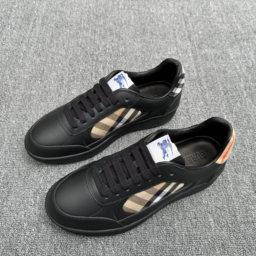 Black low-top sneakers with beige plaid side stripe and blue logo patch