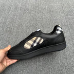 Black low-top sneaker with beige plaid side panel and lace-up front