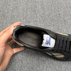 Black sneaker interior with Burberry logo on insole and lace-up opening