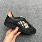 Black sneaker with beige plaid panel, lace-up front, and textured sole