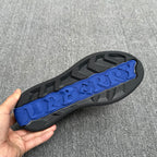 Black sneaker outsole with blue textured tread and grip pattern