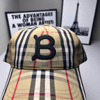 Burberry check baseball cap close-up, navy B logo on beige plaid