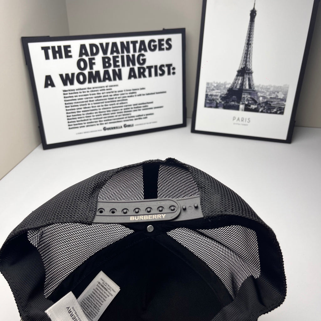 Burberry cap interior: black mesh lining with metal logo bar on the front