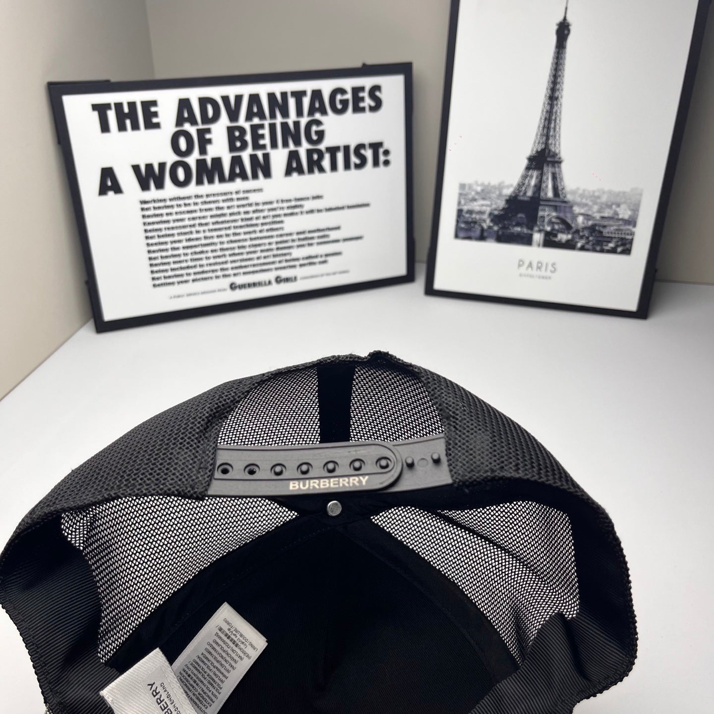 Burberry cap interior: black mesh lining with metal logo bar on the front