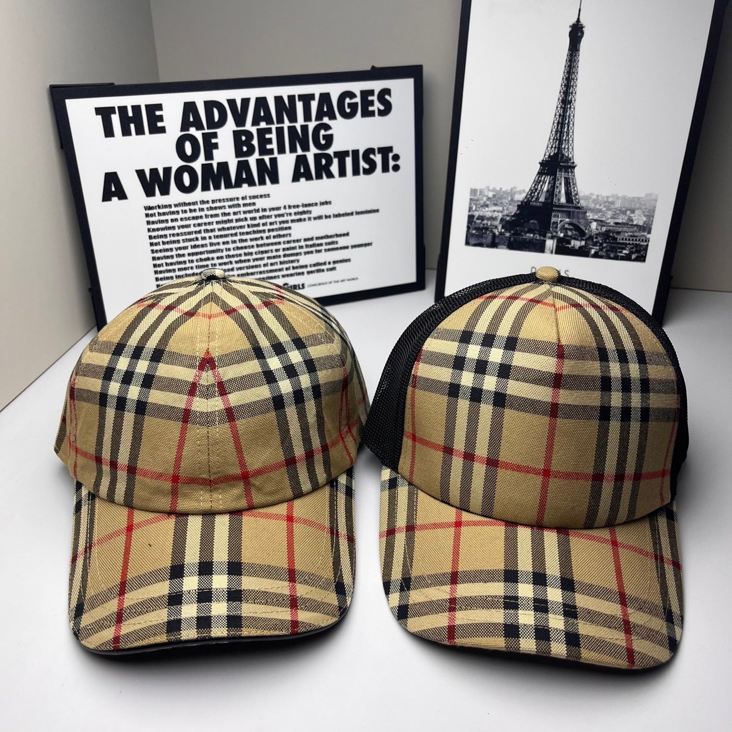 Two Burberry caps in beige, navy and red plaid with curved brims and black mesh sides