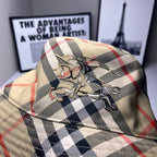 Plaid bucket cap close-up with embroidered crest, beige with navy and red checks