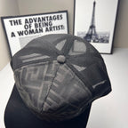 Fendi cap close-up showing dark FF pattern mesh and stitched side panel with button.