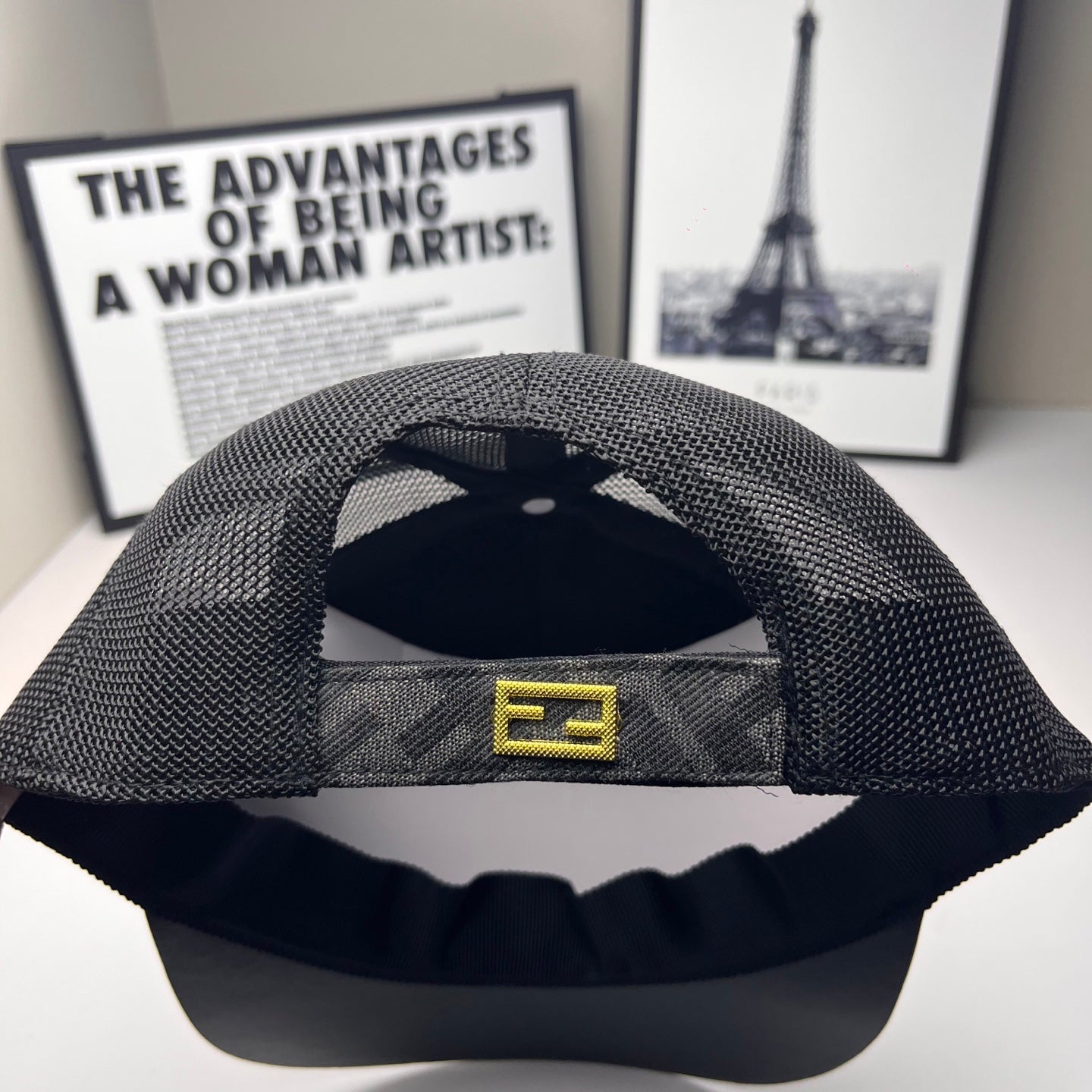 Fendi cap interior view with dark mesh crown and adjustable strap with logo tab.