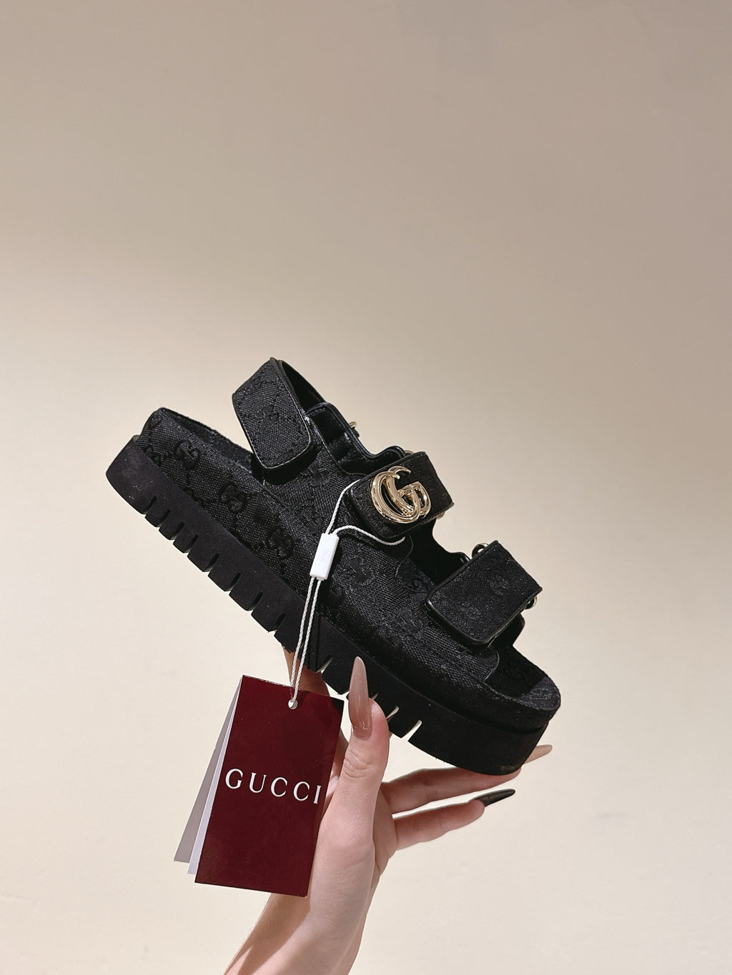 Black Gucci sandals with gold-tone GG buckle and chunky tread sole, with tag