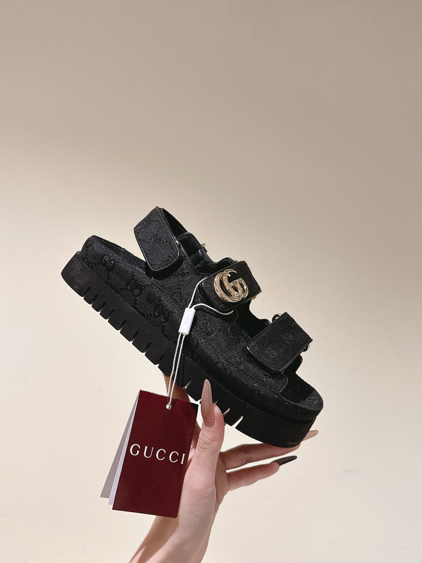 Black Gucci sandals with gold-tone GG buckle and chunky tread sole, with tag
