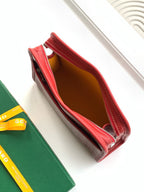 Red zip wallet open, showing brown interior lining and stitched edges