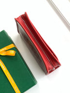 Red zip wallet side view showing stitching and brown interior lining