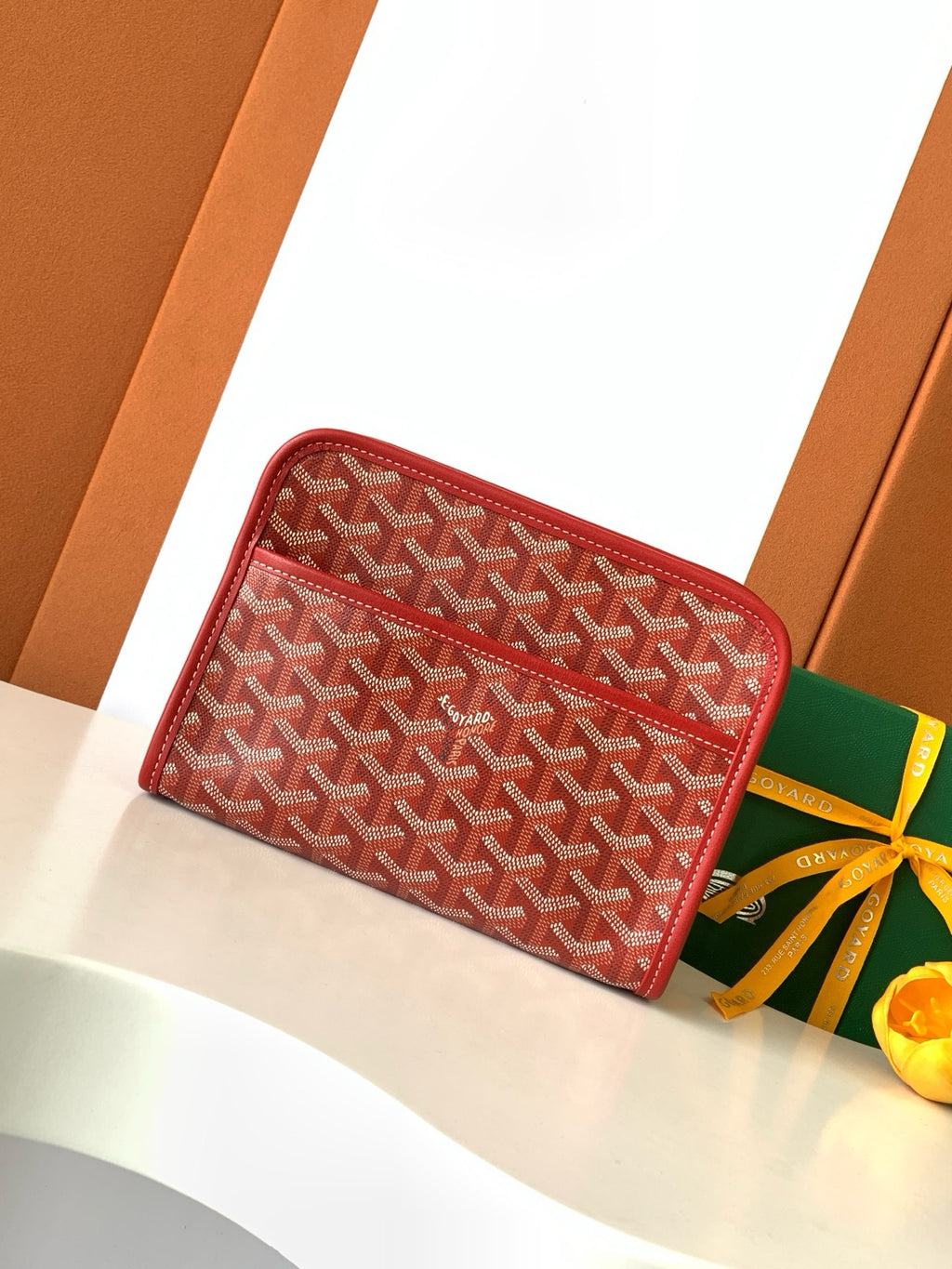 Red Goyard-pattern zip wallet with leather trim and top zip closure
