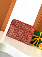 Red Goyard-pattern zip wallet with leather trim and top zip closure