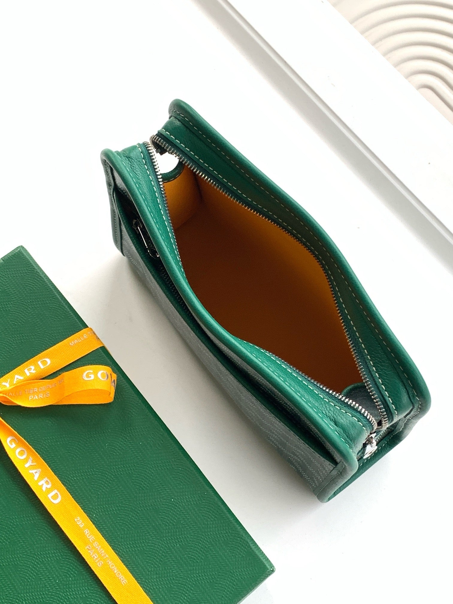 Goyard green zip wallet open, brown fabric interior visible
