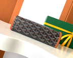 Goyard long zip pouch with dark monogram pattern and brown leather borders