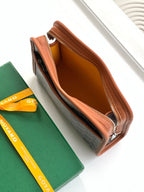 Goyard zip pouch open, showing tan lining and brown leather interior