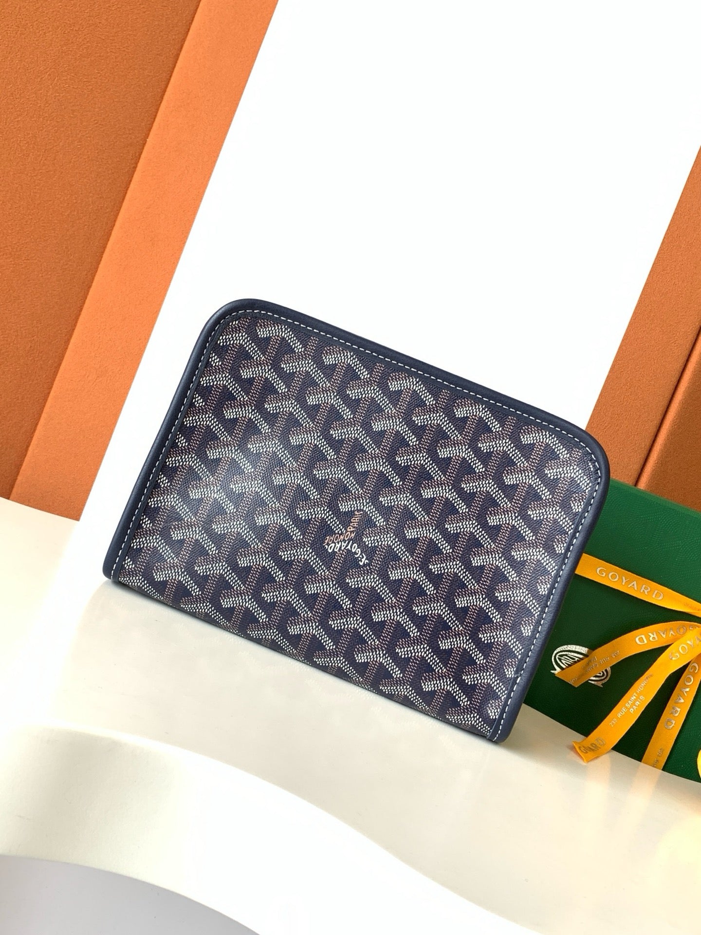 Navy Goyard pattern zip wallet clutch front view with top zipper