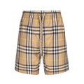 Plaid drawstring shorts with elastic waistband, beige and black checks with yellow lines