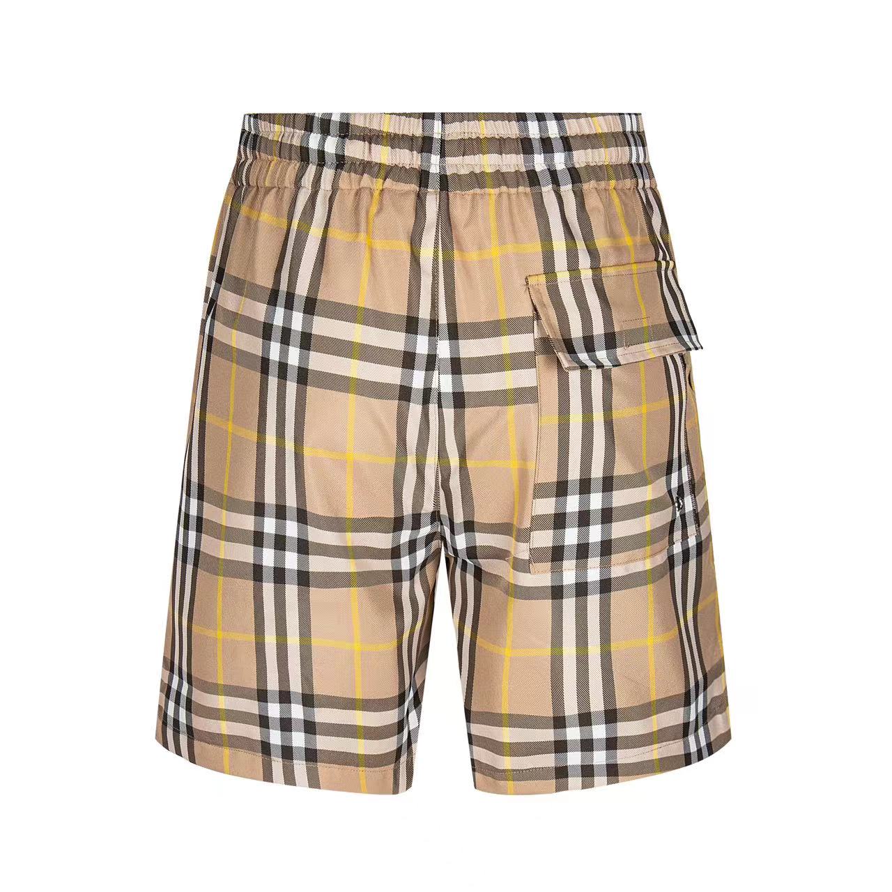 Plaid shorts with elastic waistband, drawstring, and side patch pocket detail