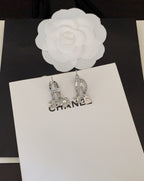 Silver-tone rhinestone Chanel hoop earrings with CC charm details