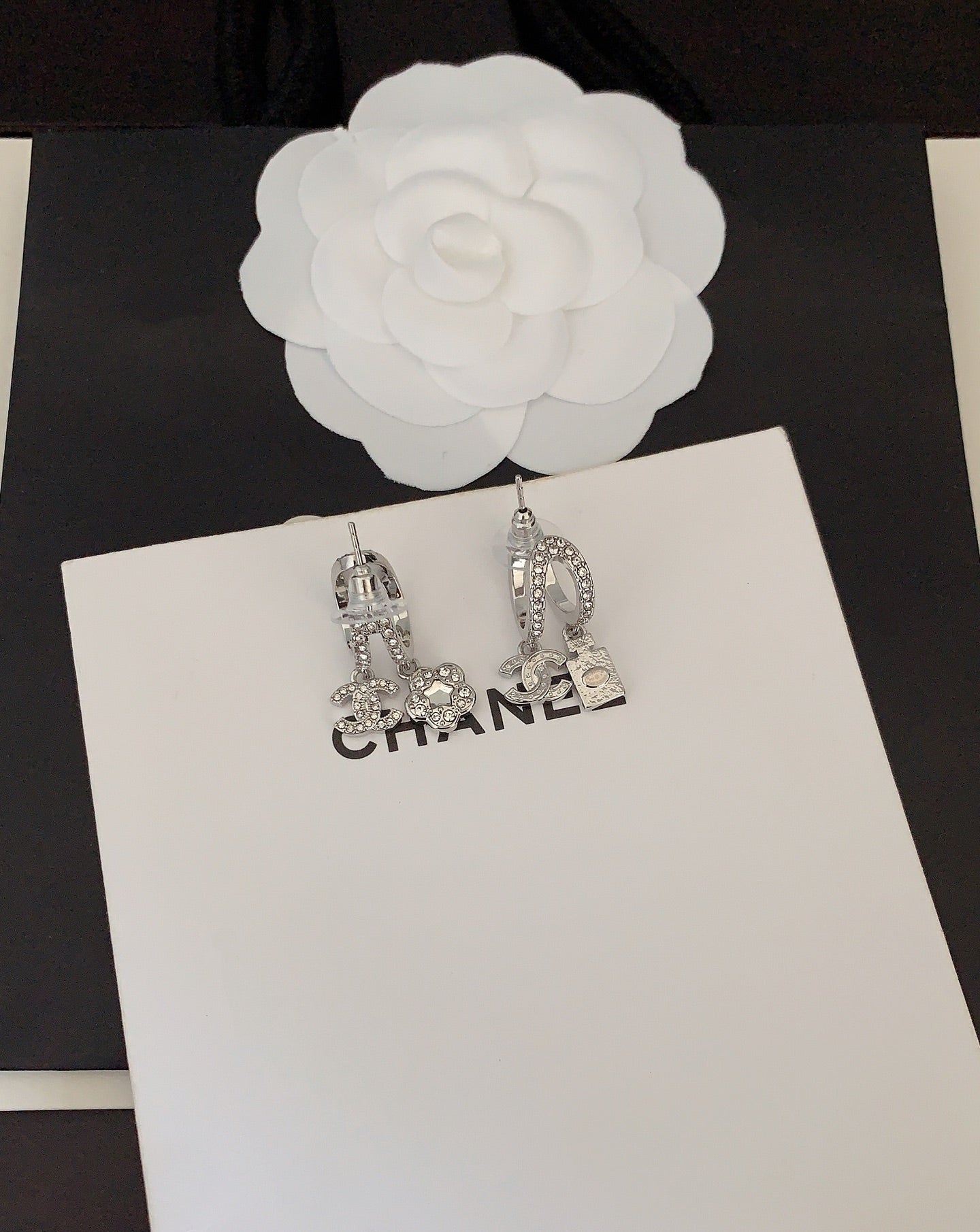 Silver-tone rhinestone Chanel hoop earrings with CC charm details