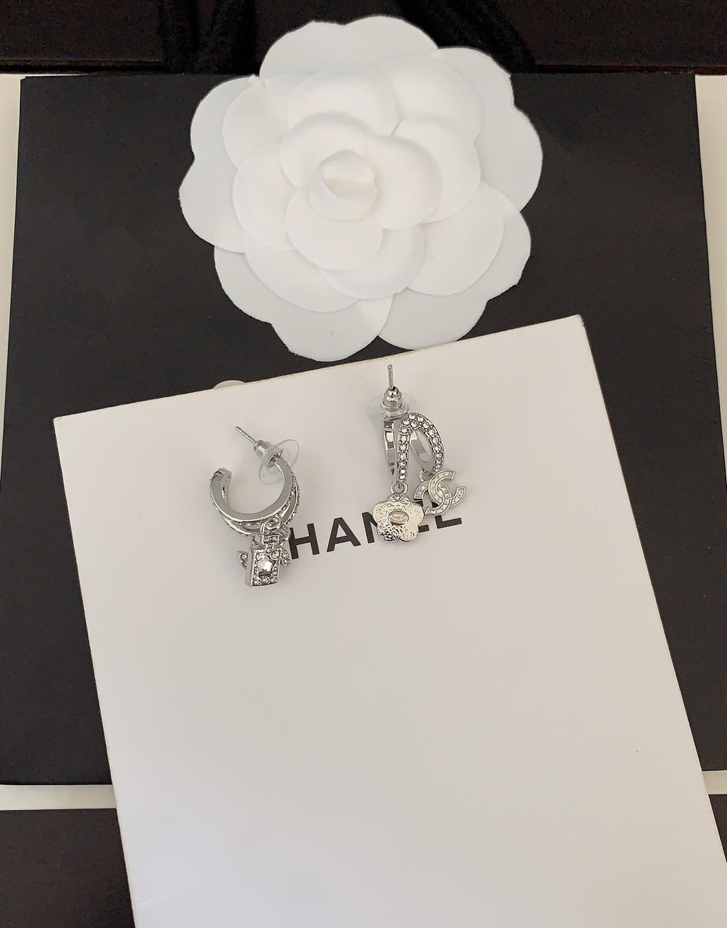 Silver-tone rhinestone Chanel hoop earrings with CC charm detail