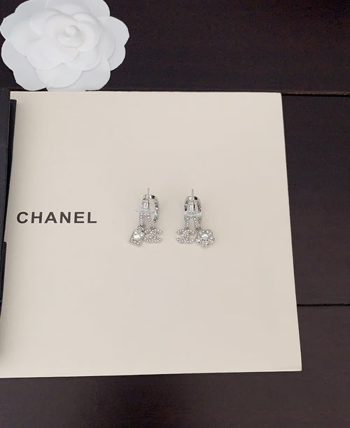 Silver-tone rhinestone Chanel stud earrings with dangling charms