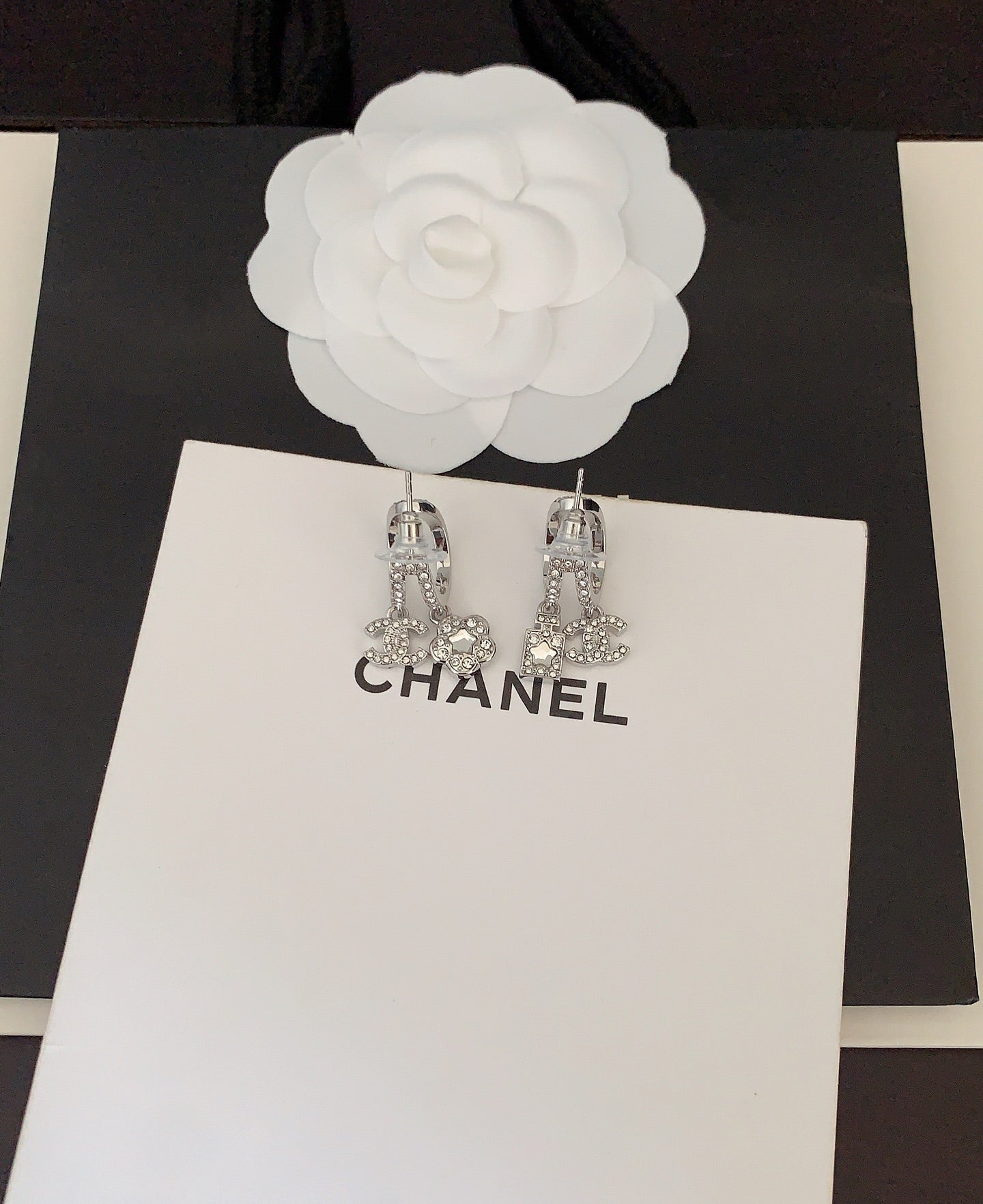 Silver-tone rhinestone Chanel drop earrings with CC charms
