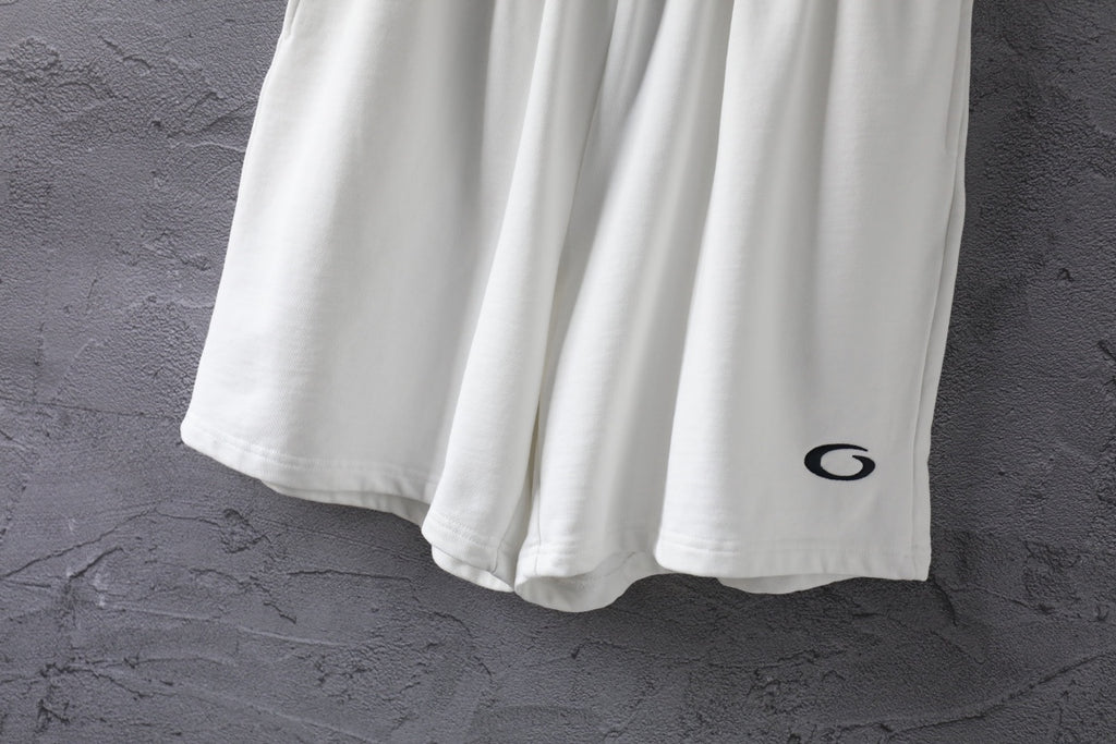 White shorts lower half with black oval logo on the right leg.