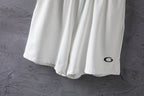 White shorts lower half with black oval logo on the right leg.
