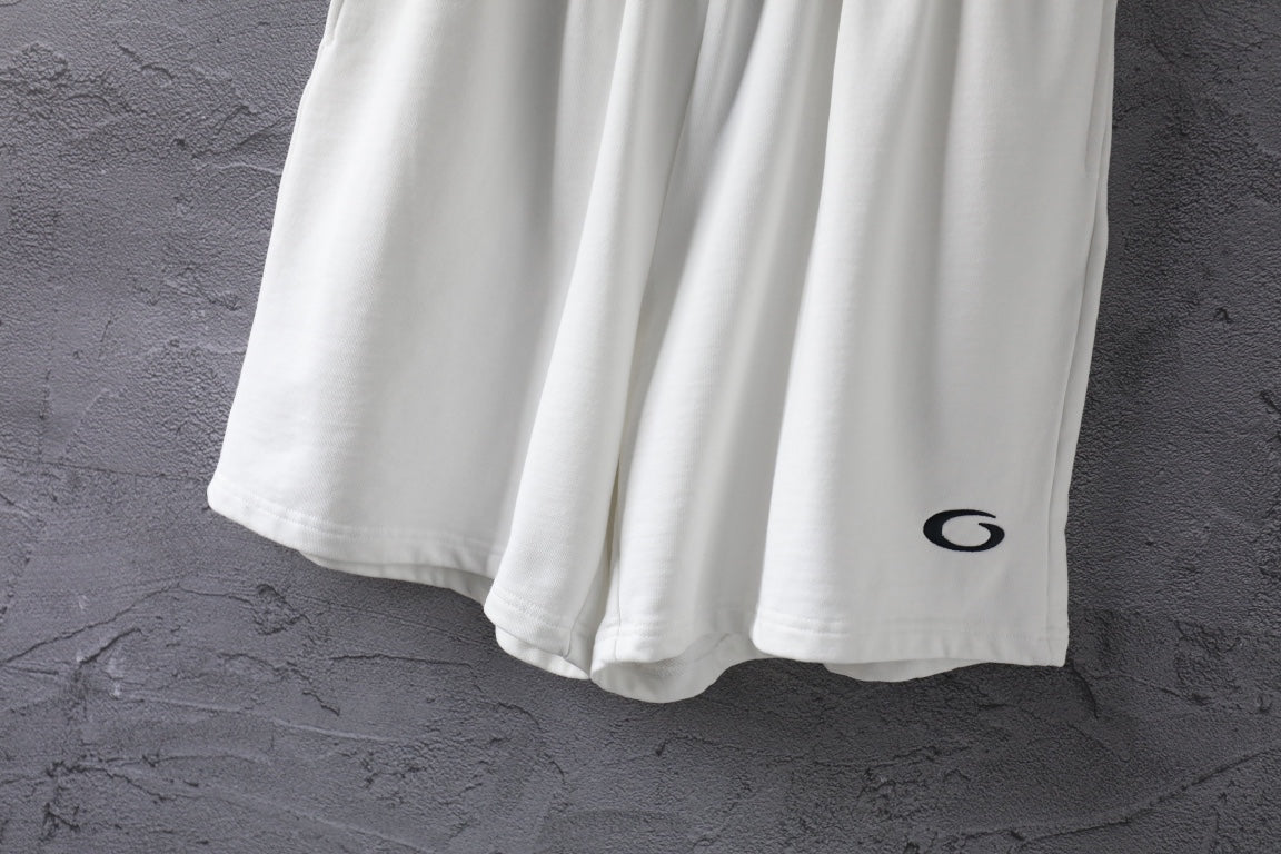 White shorts lower half with black oval logo on the right leg.
